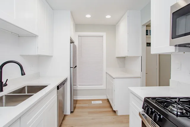 a kitchen with stainless steel appliances a refrigerator and a sink
