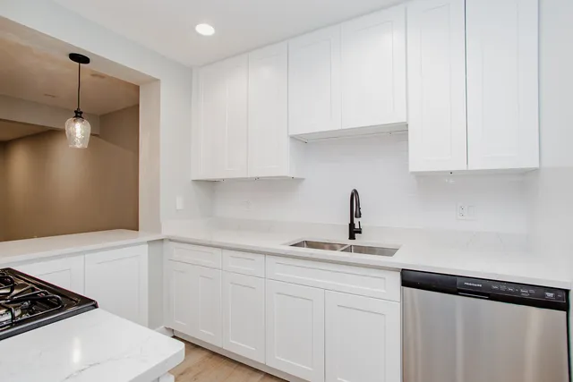 a kitchen with a sink and cabinets