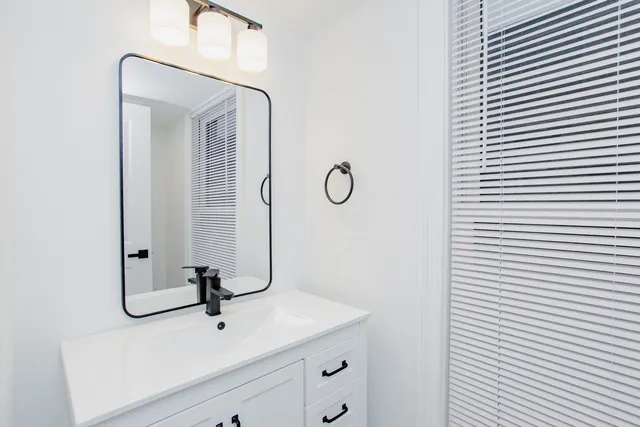 a bathroom with a sink and mirror