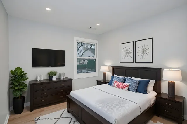 a bedroom with a bed and a flat screen tv