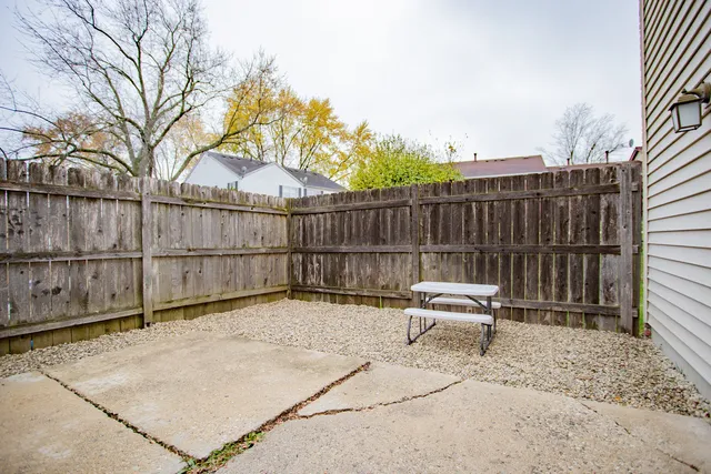 a view of backyard with wooden fence