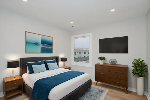 a bedroom with a bed and a flat screen tv