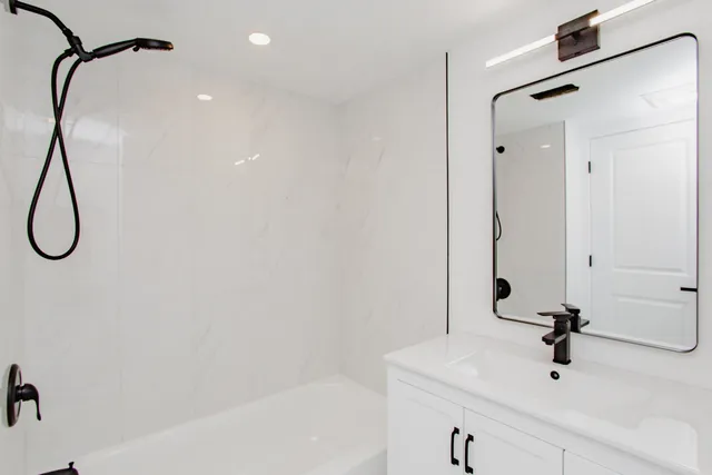 a bathroom with a shower and a sink