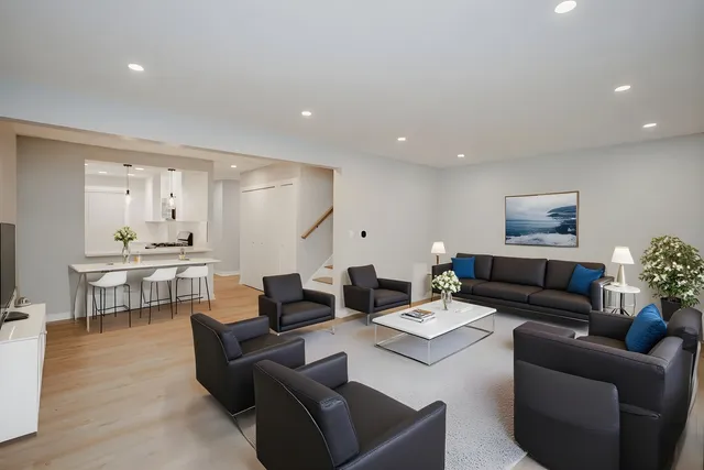 a living room with furniture kitchen view and a table