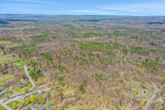 a view of a field with beach and background