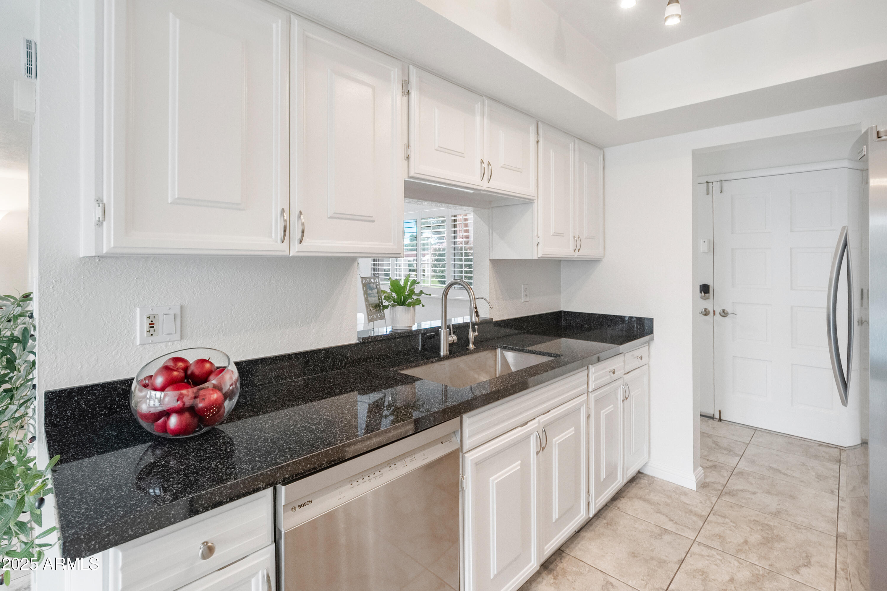 3928 North Granite Reef Road Scottsdale, AZ 85251 - Photo 11 of 30 a kitchen with granite countertop white cabinets and a sink