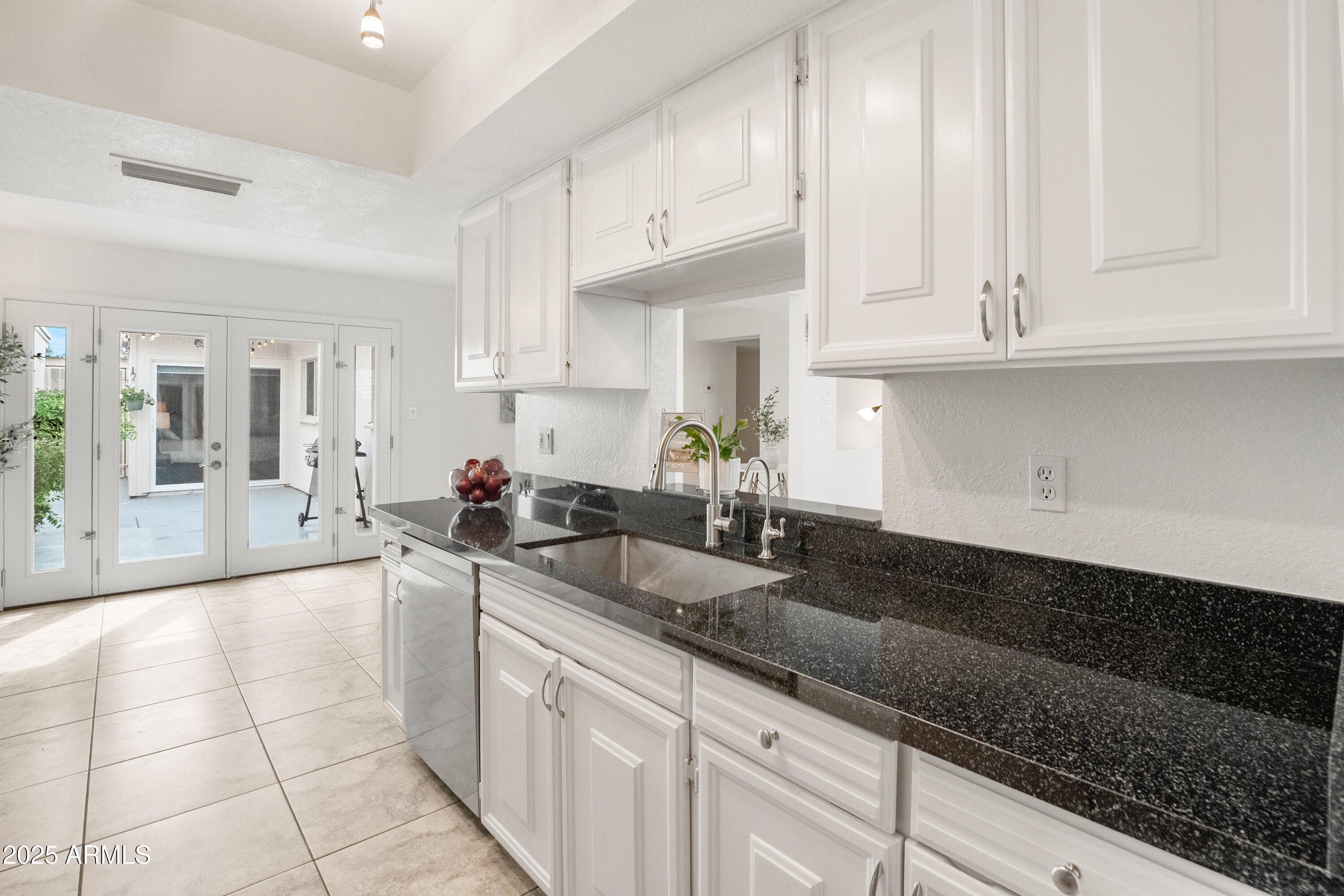 3928 North Granite Reef Road Scottsdale, AZ 85251 - Photo 14 of 30 a large kitchen with granite countertop a sink and white cabinets