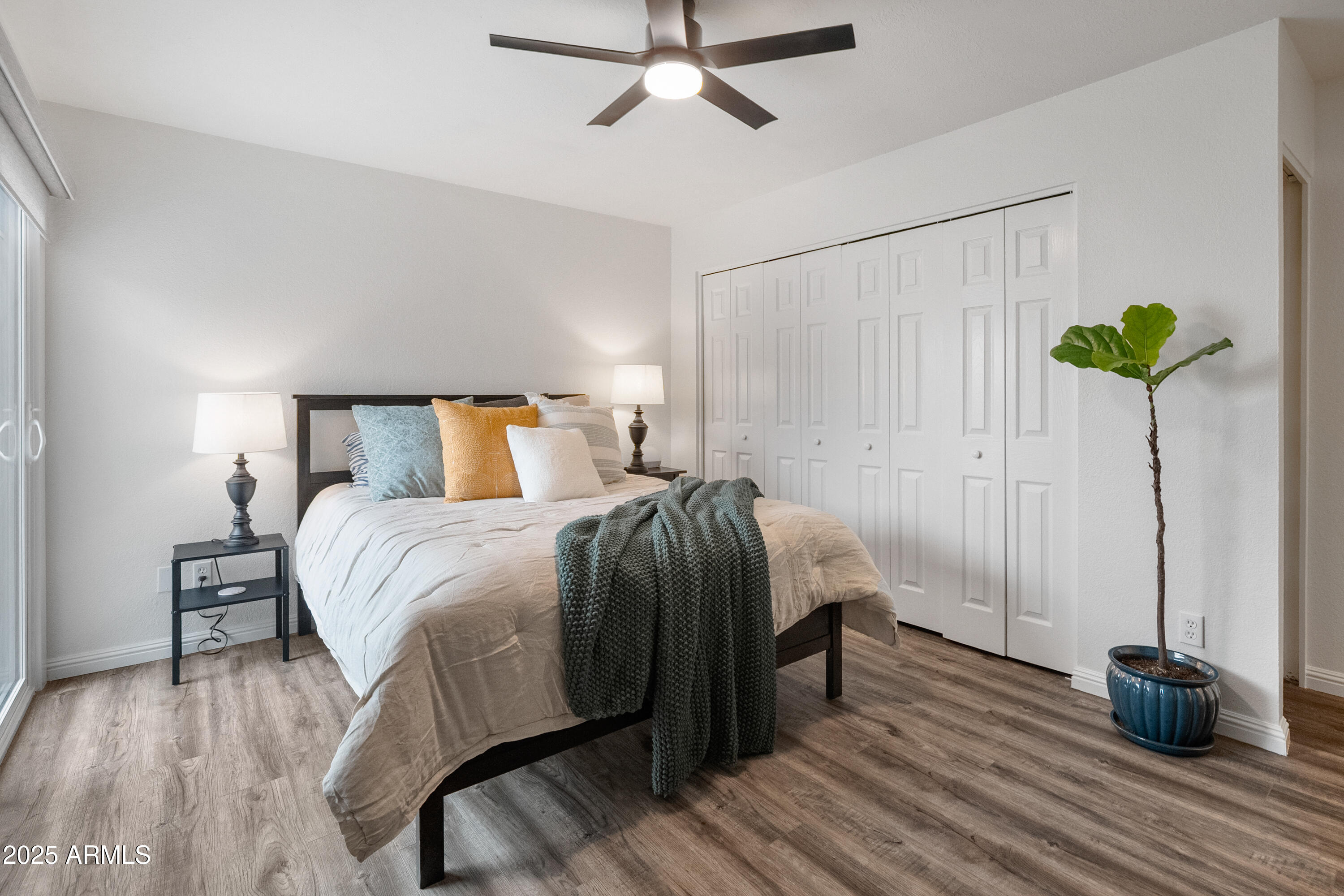 3928 North Granite Reef Road Scottsdale, AZ 85251 - Photo 4 of 30 a bedroom with a bed and wooden floor