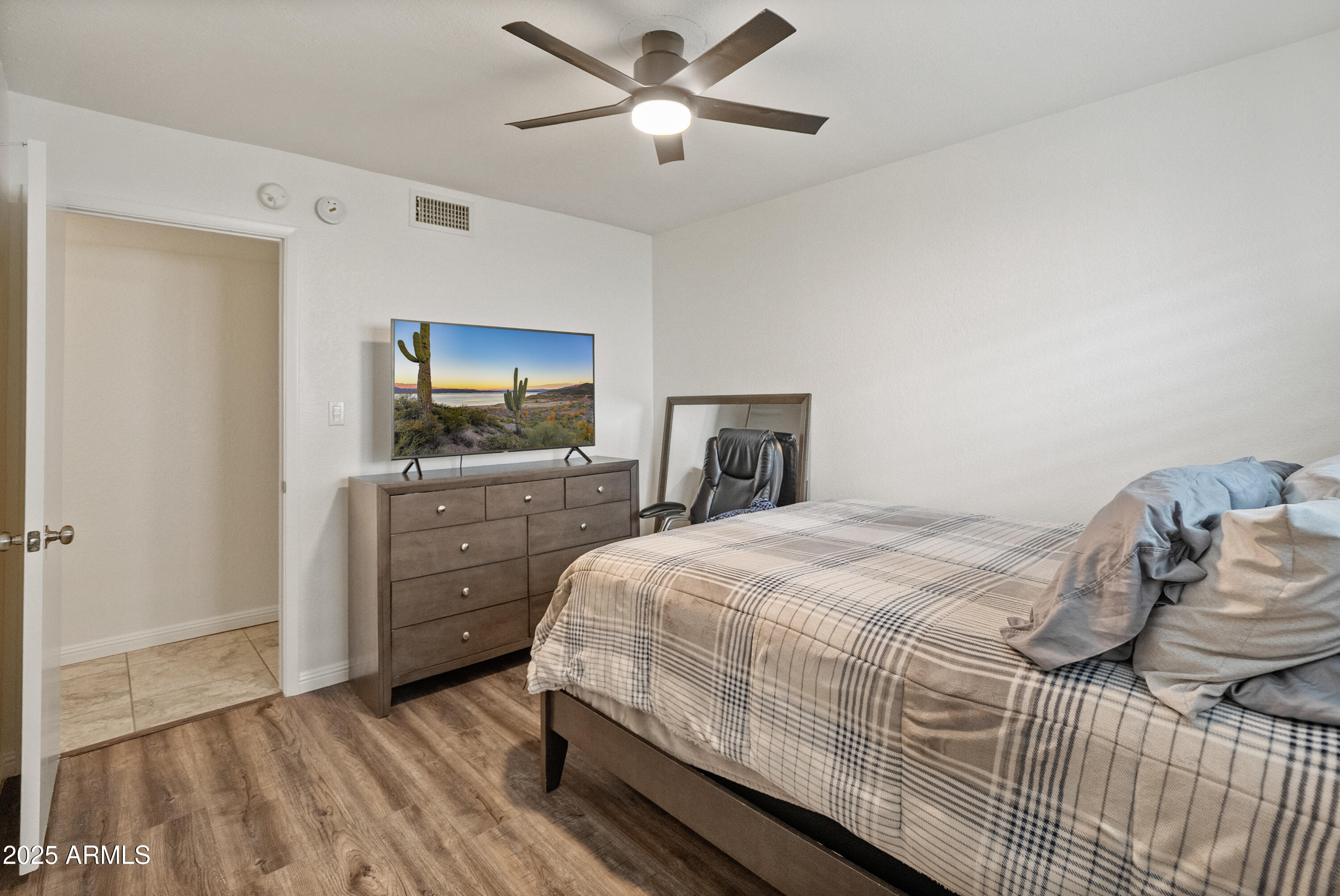 3928 North Granite Reef Road Scottsdale, AZ 85251 - Photo 7 of 30 a bedroom with a bed and a flat screen tv