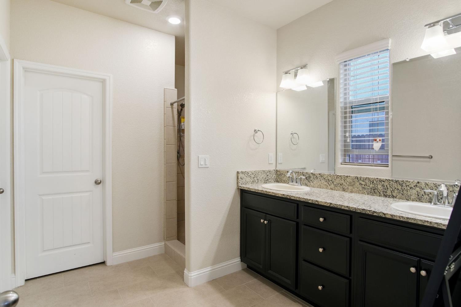 3790 Bonifacio Way Merced, CA 95340 - Photo 14 of 21 a bathroom with a granite countertop sink and a mirror