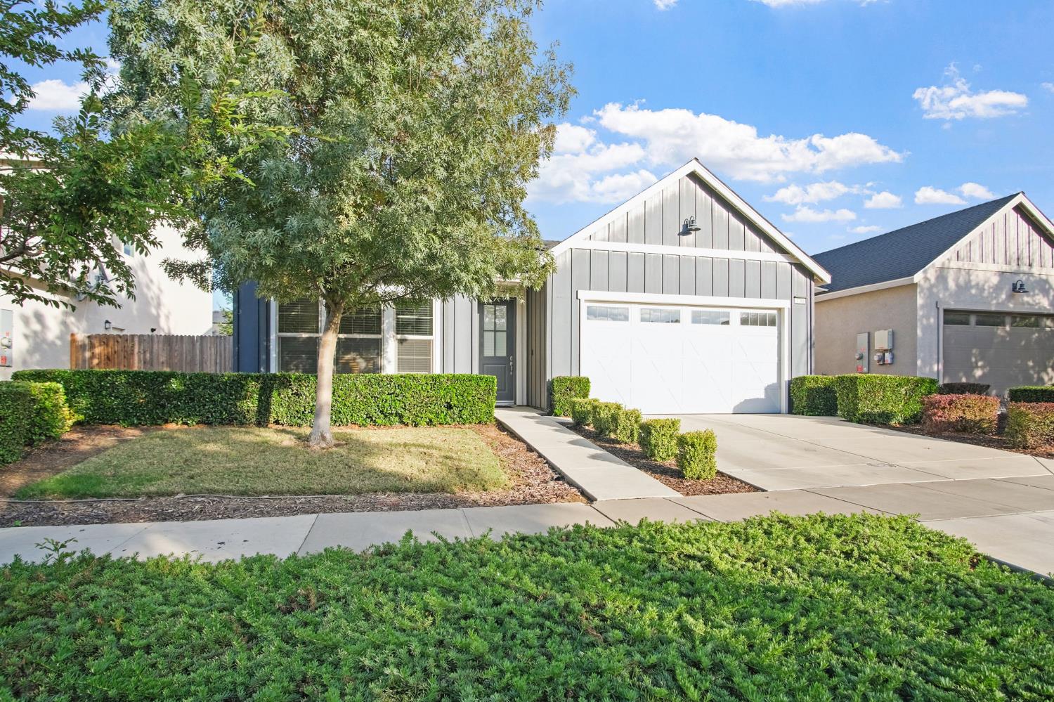 3790 Bonifacio Way Merced, CA 95340 - Photo 2 of 21 a front view of a house with a yard and garage