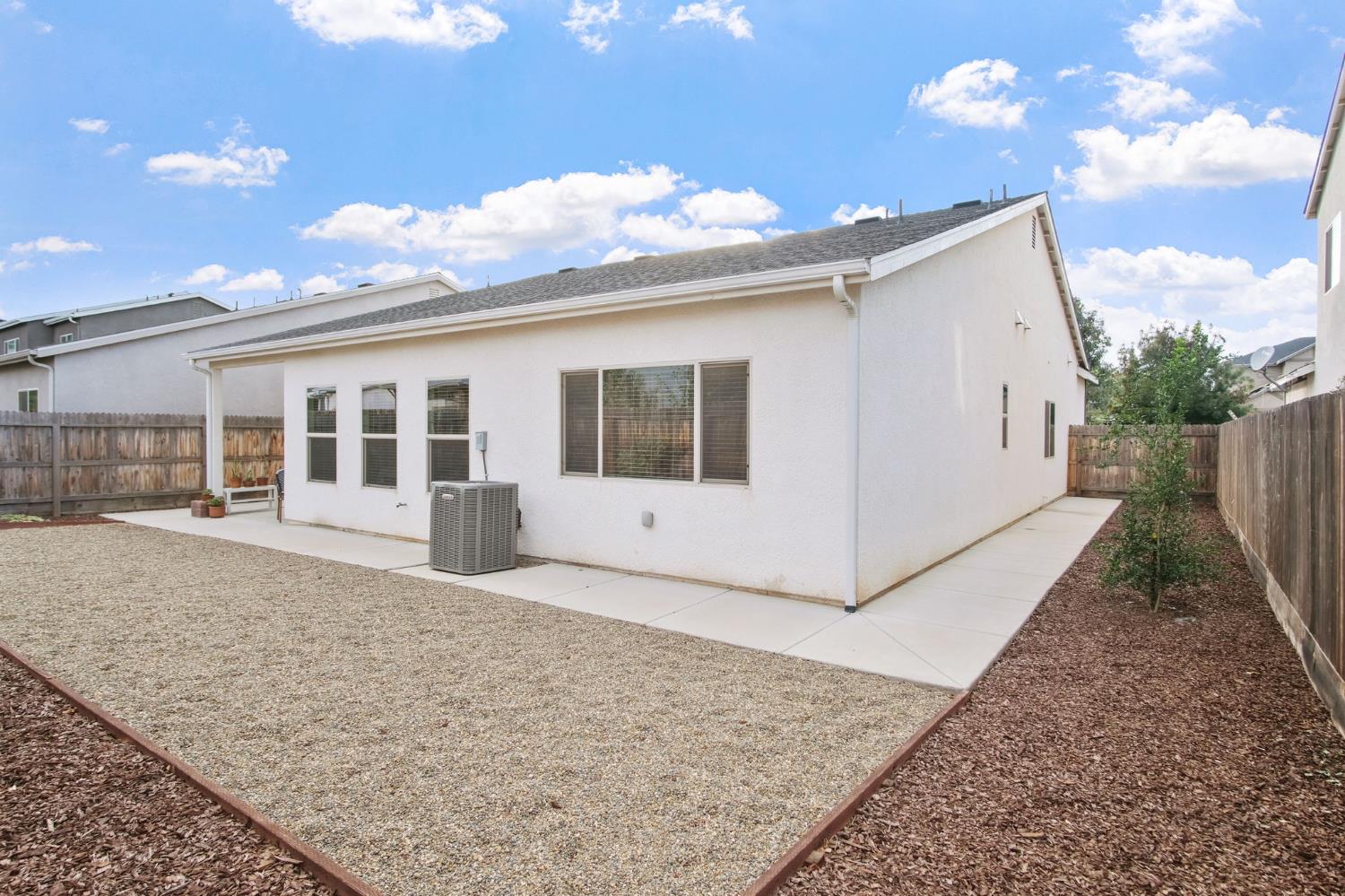3790 Bonifacio Way Merced, CA 95340 - Photo 21 of 21 a view of a white house with a yard