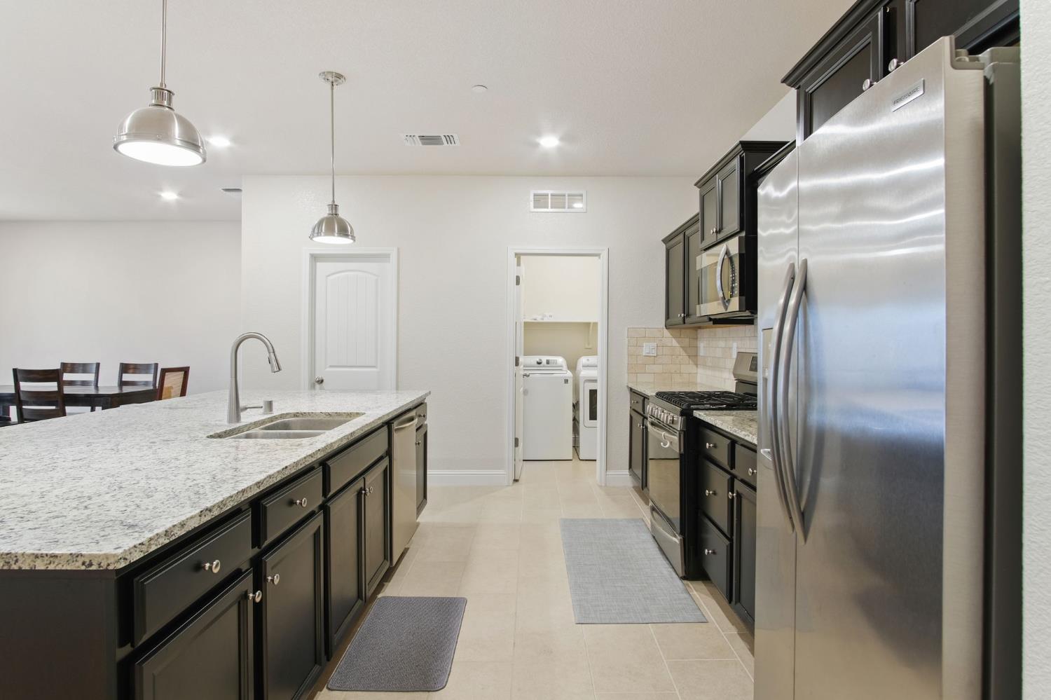 3790 Bonifacio Way Merced, CA 95340 - Photo 9 of 21 a kitchen with granite countertop a sink appliances and cabinets