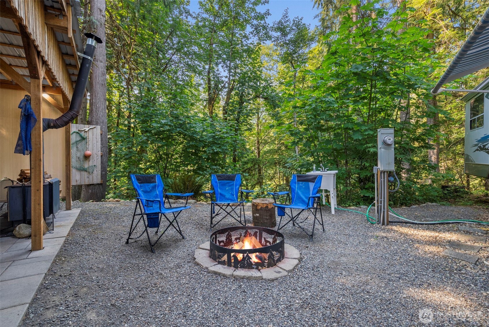 560 North Beacon Point Loop North Lilliwaup, WA 98555 - Photo 14 of 40 a backyard of a house with table and chairs