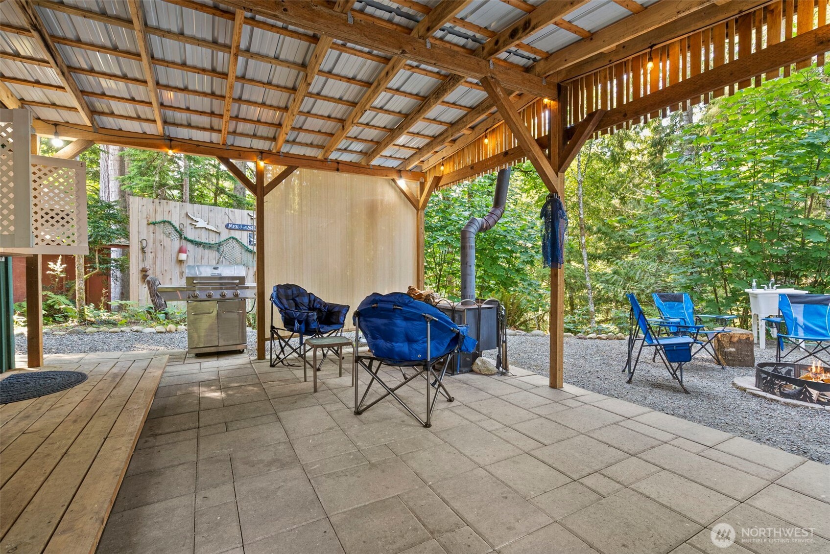 560 North Beacon Point Loop North Lilliwaup, WA 98555 - Photo 16 of 40 a view of a chairs and table in backyard of the house