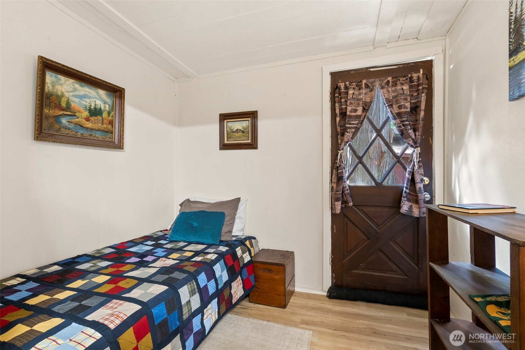 560 North Beacon Point Loop North Lilliwaup, WA 98555 - Photo 19 of 40 a bedroom with a bed and wooden floor