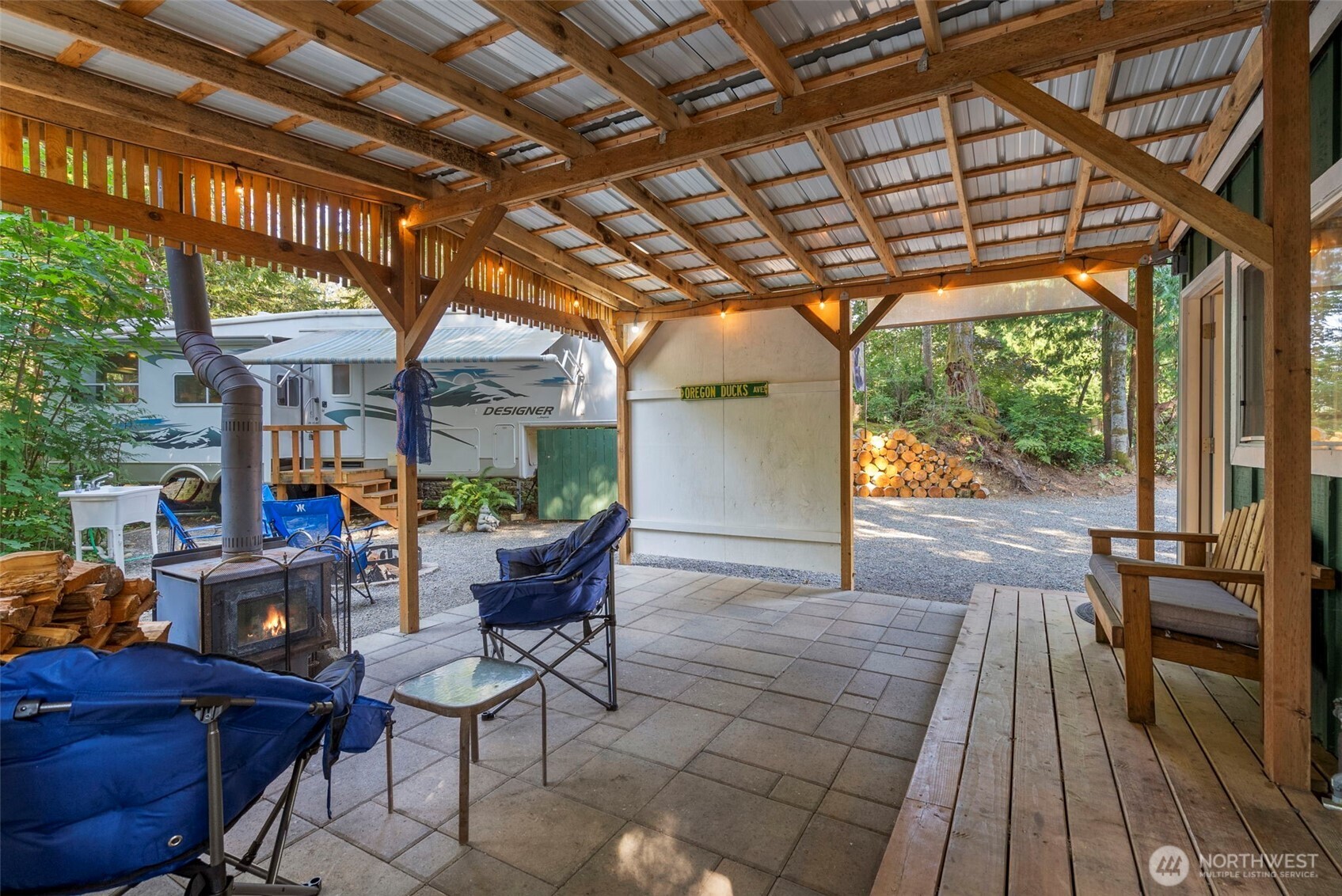 560 North Beacon Point Loop North Lilliwaup, WA 98555 - Photo 21 of 40 a view of a patio with table and chairs and potted plants