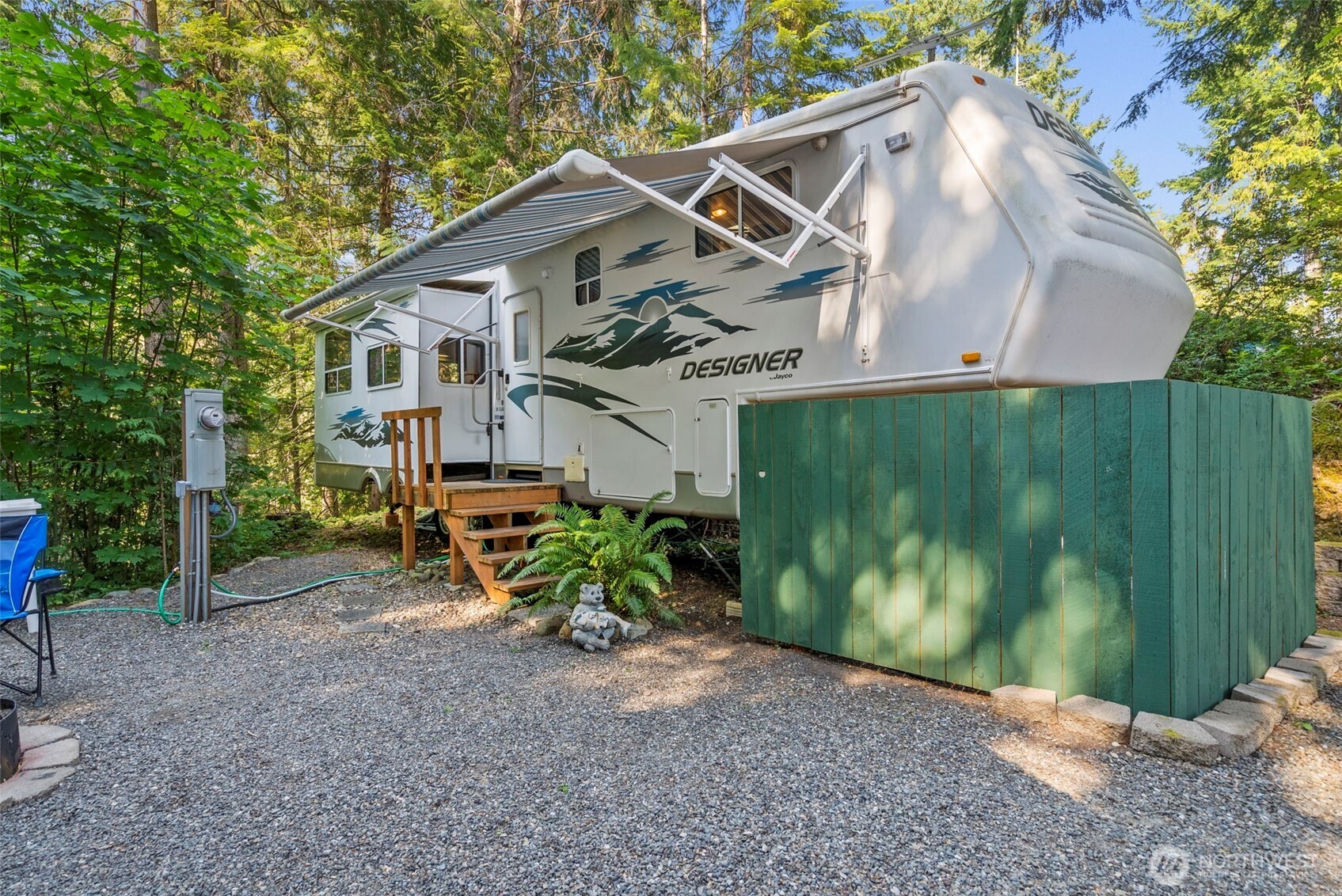 560 North Beacon Point Loop North Lilliwaup, WA 98555 - Photo 3 of 40 a view of a house with wooden fence next to a yard