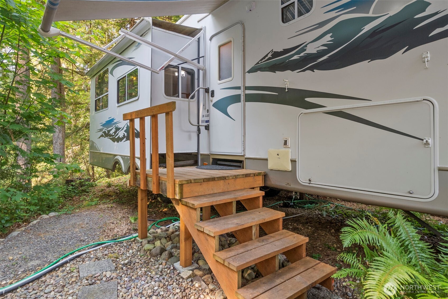 560 North Beacon Point Loop North Lilliwaup, WA 98555 - Photo 4 of 40 a front view of a house with a yard