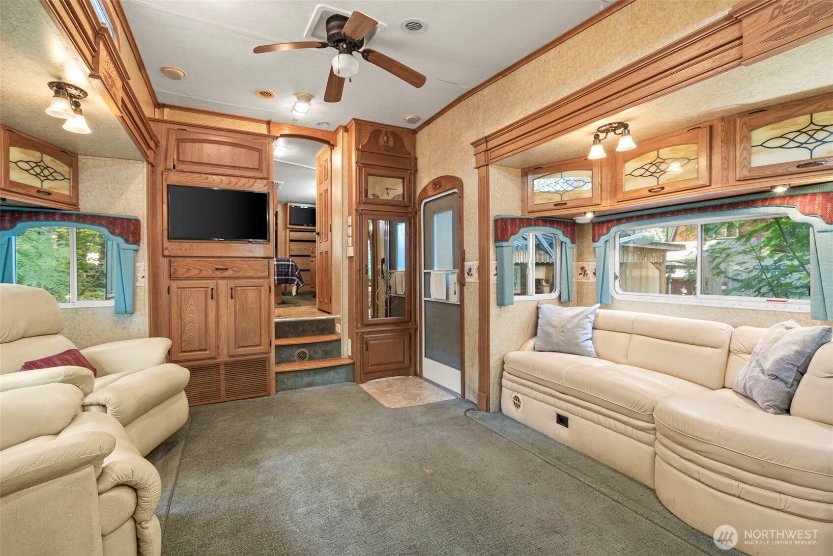 560 North Beacon Point Loop North Lilliwaup, WA 98555 - Photo 5 of 40 a living room with furniture a flat screen tv and a fireplace