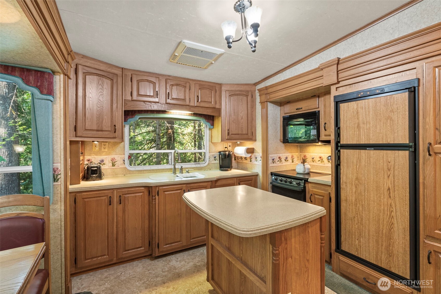 560 North Beacon Point Loop North Lilliwaup, WA 98555 - Photo 7 of 40 a kitchen with a sink a stove and cabinets