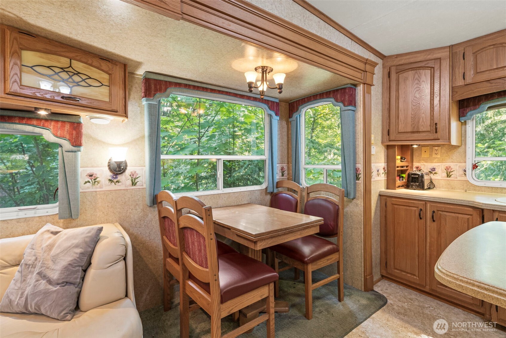 560 North Beacon Point Loop North Lilliwaup, WA 98555 - Photo 8 of 40 a living room with furniture a large window and a table