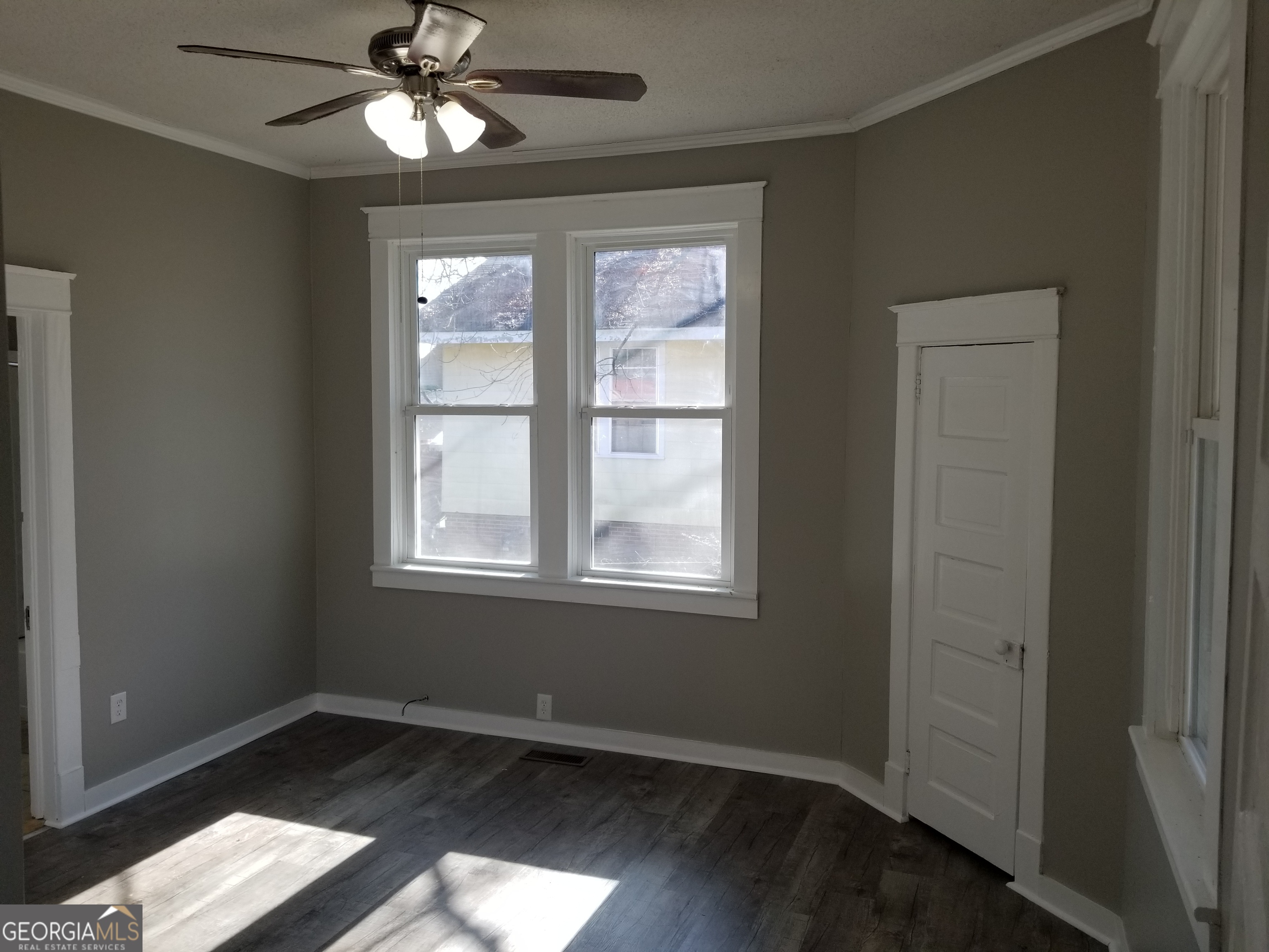 215 4th Street Rome, GA 30161 - Photo 5 of 12 a view of an empty room with wooden floor and a window