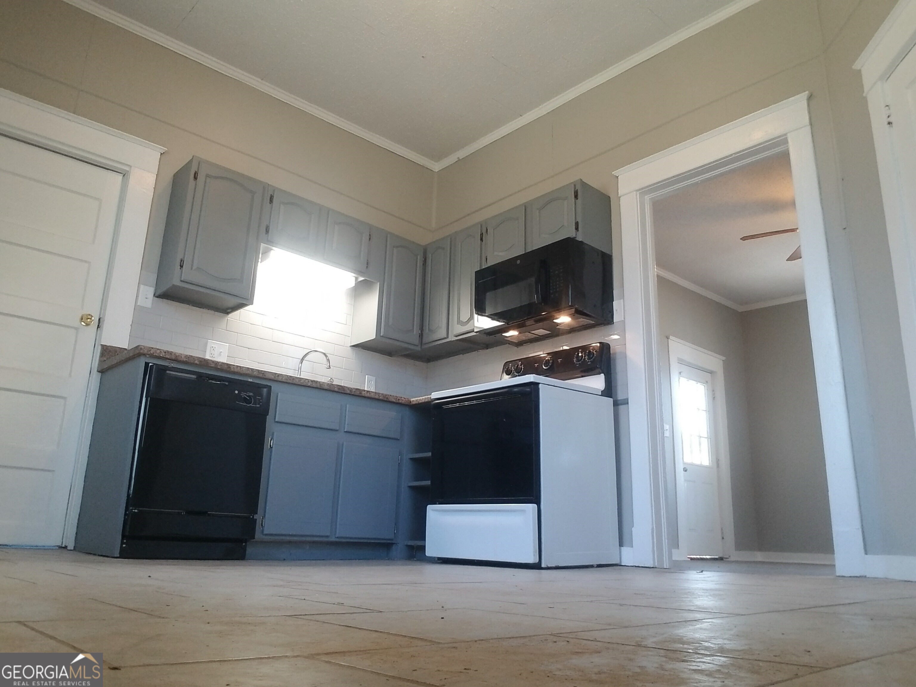 215 4th Street Rome, GA 30161 - Photo 8 of 12 a kitchen with stainless steel appliances granite countertop a stove a microwave and a refrigerator