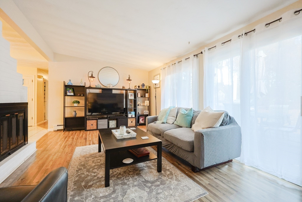 11 Edith Road Framingham, MA 01701 - Photo 13 of 37 a living room with furniture a fireplace and a large window