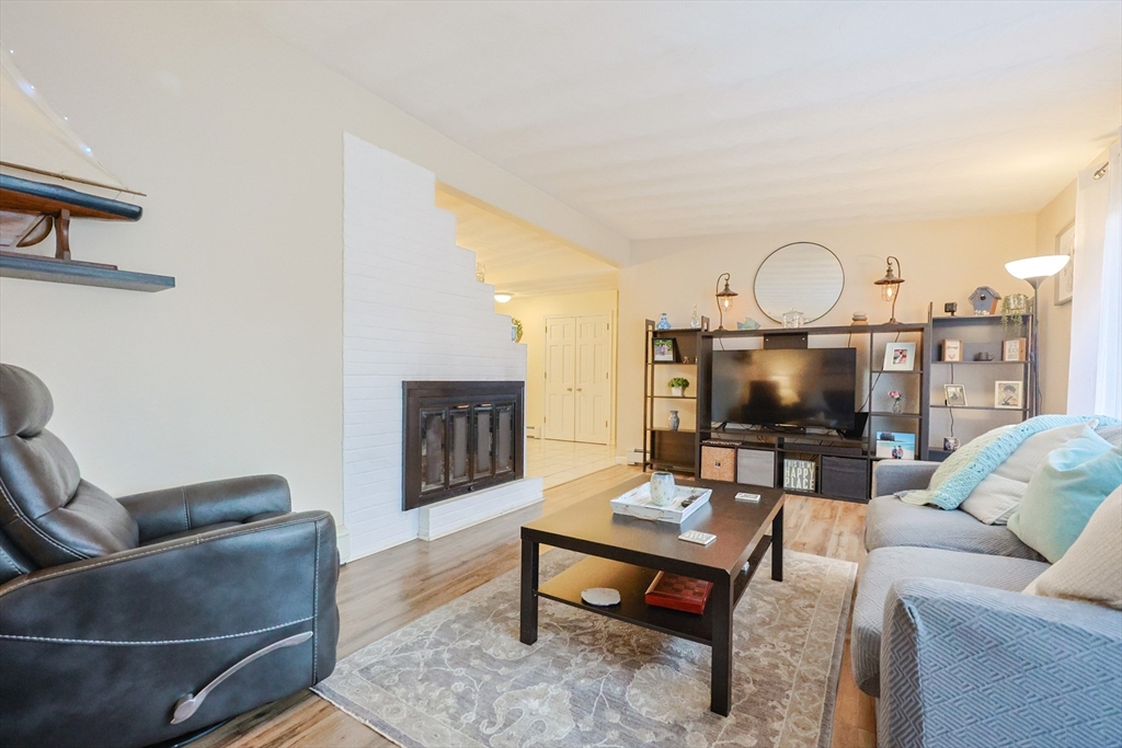 11 Edith Road Framingham, MA 01701 - Photo 14 of 37 a living room with furniture a flat screen tv and a fireplace