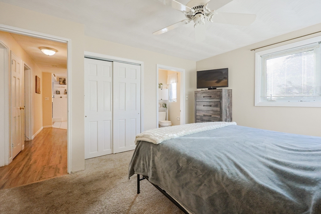 11 Edith Road Framingham, MA 01701 - Photo 18 of 37 a spacious bedroom with a bed and a chandelier