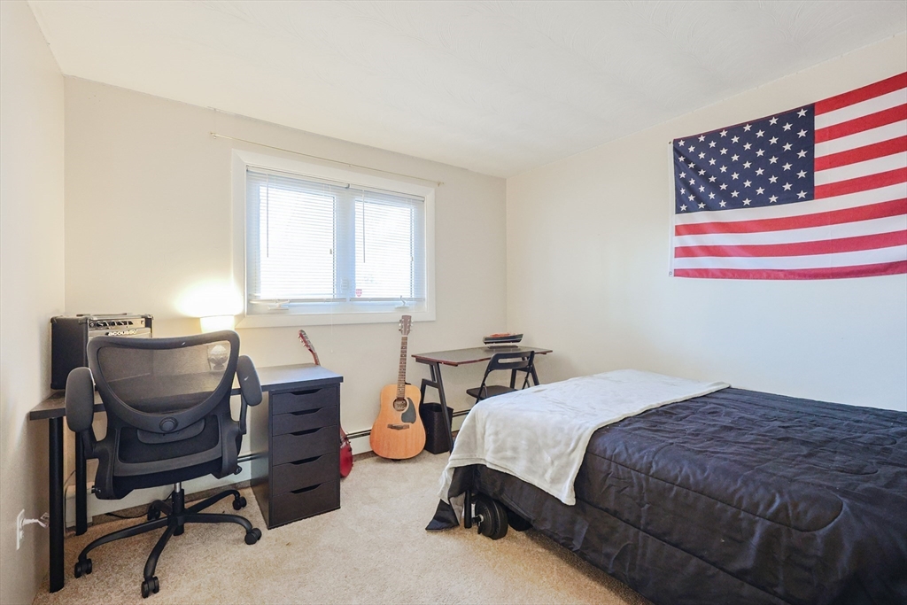 11 Edith Road Framingham, MA 01701 - Photo 24 of 37 a bedroom with a bed chair and piano