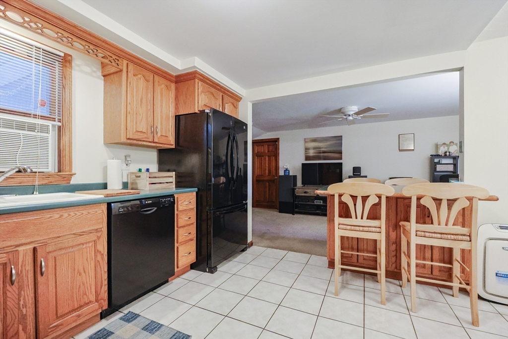 11 Edith Road Framingham, MA 01701 - Photo 8 of 37 a kitchen with stainless steel appliances granite countertop a refrigerator and wooden cabinets
