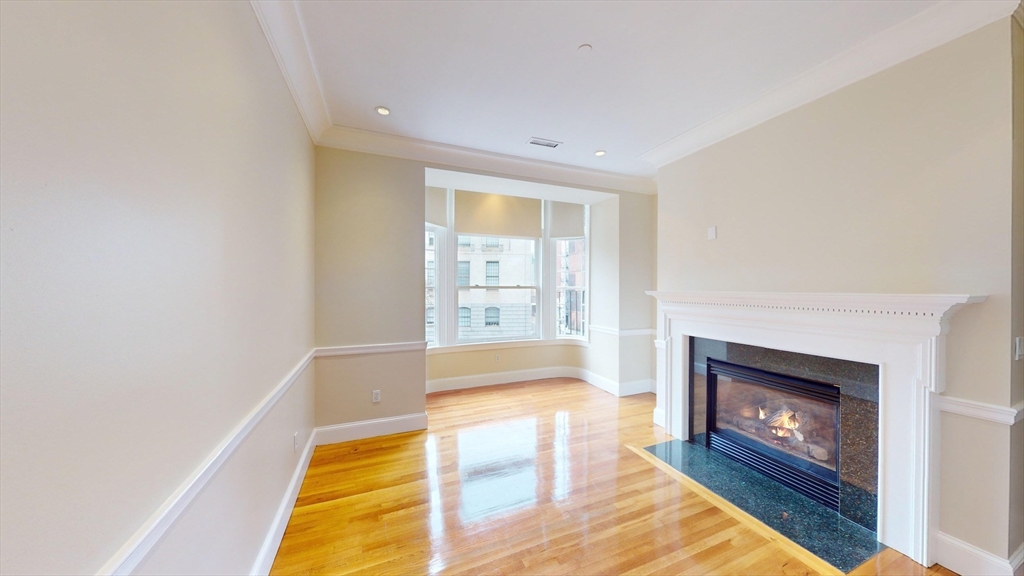 22 Beacon Street, Unit 3 Boston, MA 02108 - Photo 14 of 28 a living room with stainless steel appliances furniture a rug and a fireplace