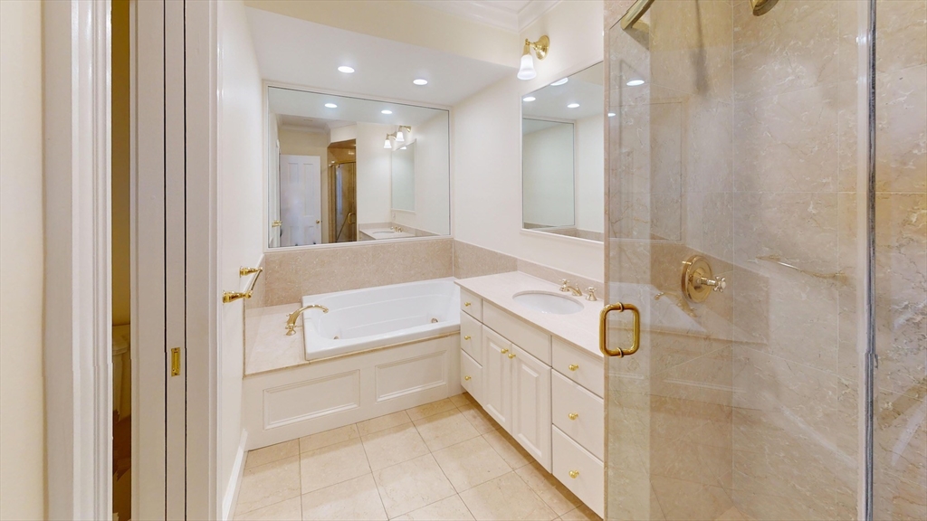 22 Beacon Street, Unit 3 Boston, MA 02108 - Photo 19 of 28 a bathroom with a double vanity sink a mirror and a shower