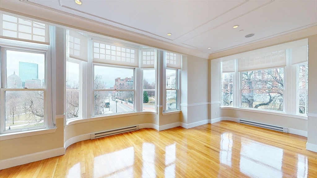 22 Beacon Street, Unit 3 Boston, MA 02108 - Photo 2 of 28 a room with a large window and a bed