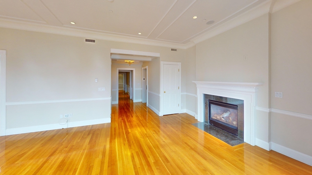 22 Beacon Street, Unit 3 Boston, MA 02108 - Photo 22 of 28 a bedroom with a bed and a fireplace