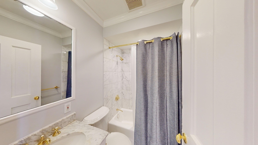 22 Beacon Street, Unit 3 Boston, MA 02108 - Photo 25 of 28 a bathroom with a shower curtain and a sink