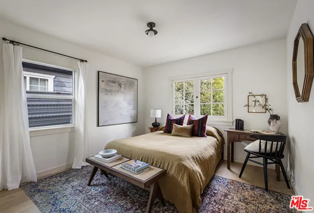 a bedroom with a bed and a window