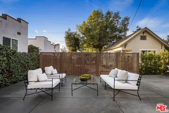 a backyard of a house with table and chairs