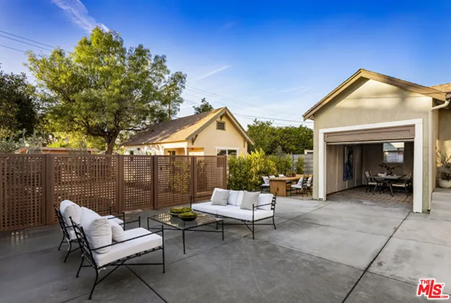 a view of a house with a yard and sitting area