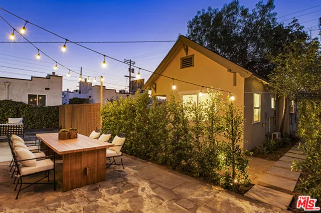 a outdoor space with a table and chairs