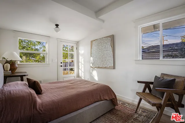 a bedroom with a bed and window