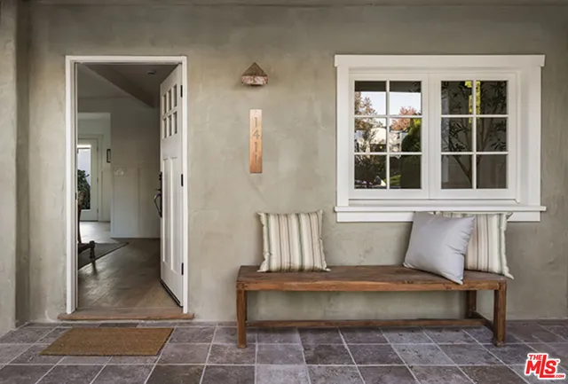 a view of a hallway with wooden floor and a glass door