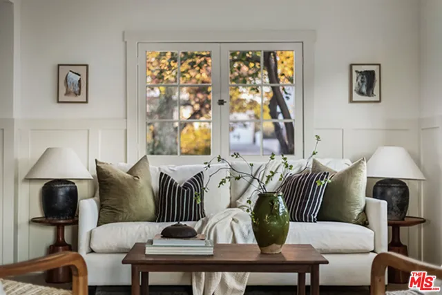 a living room with furniture and a lamp