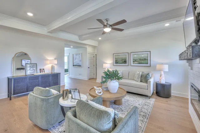 a kitchen with stainless steel appliances granite countertop a stove top oven a sink dishwasher a dining table and chairs with wooden floor