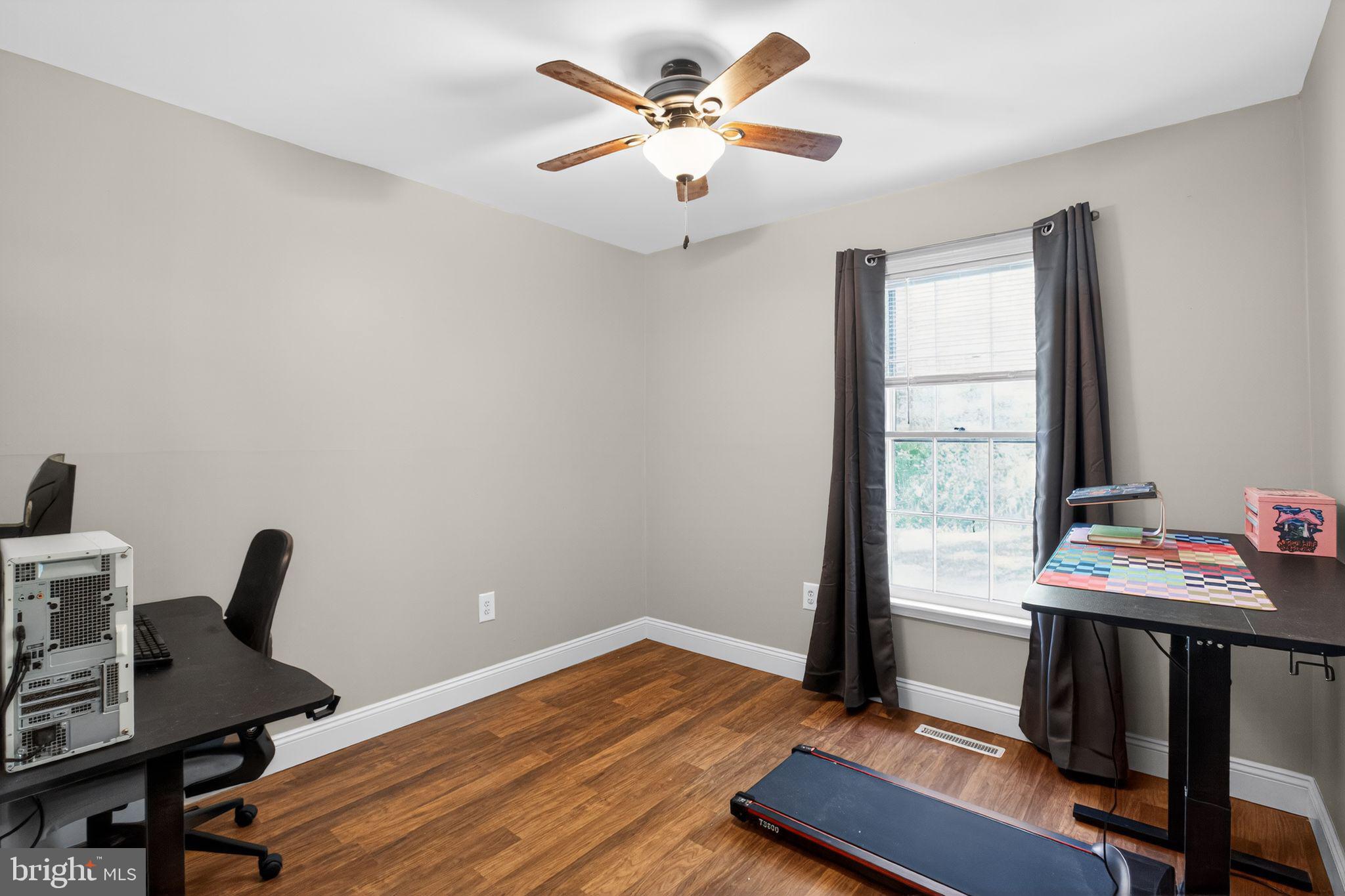 11789 Little Cove Point Road Lusby, MD 20657 - Photo 15 of 16 a view of a workspace with furniture and a window