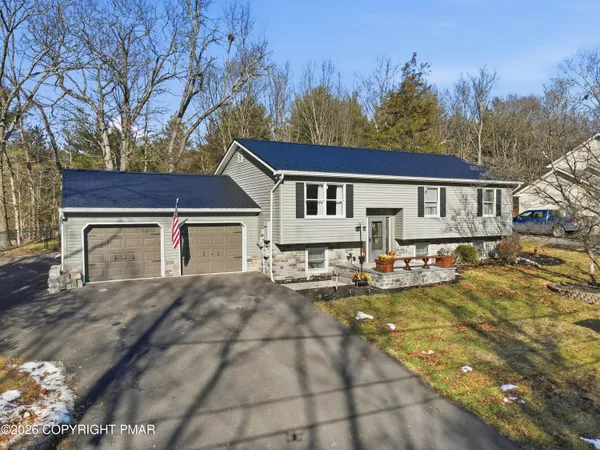 a view of a yard with a house in the background