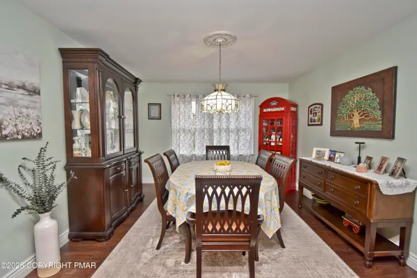 a dining room with furniture and window