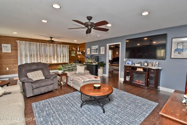 a living room with furniture and a flat screen tv